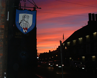 The Chaucer Head sign at dusk